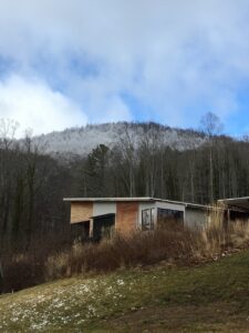 An image of a building on a hillside with a beautiful vista in the distance