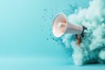 An image of a handheld loud speaker about to be enveloped by whiteish blueish smoke